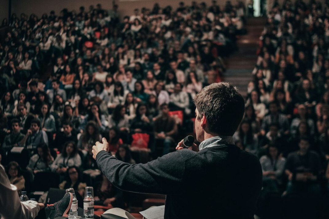person speaking on stage confidently